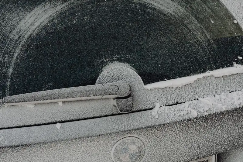 A car door and window glazed with frost