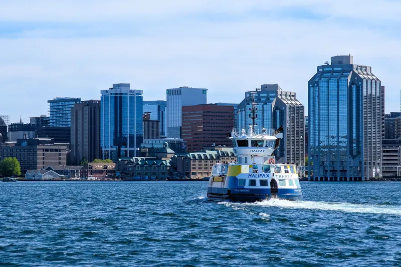 A harbour ferry crossing toward the downtown Halifax waterfront on a sunny day